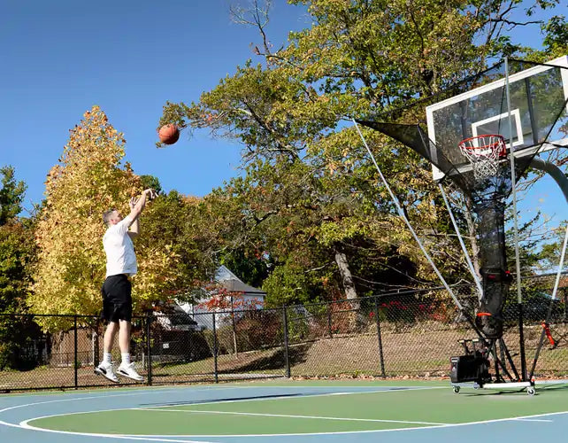 picture of player using APEX shooting machine at a park shooting a jump shot.