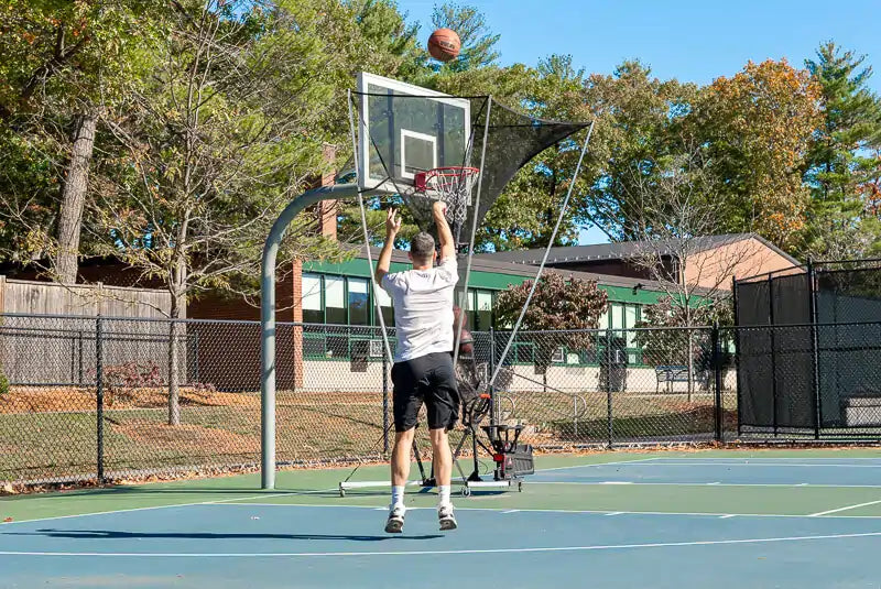 man shoots with high arc on the apex basketball shooting machine